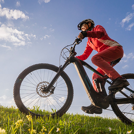 female on a mountain bike, riding across the country side